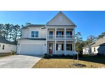 Charming two-story home with a covered porch and well-maintained lawn at 7136 Shooting Star Way, Myrtle Beach, SC 29579