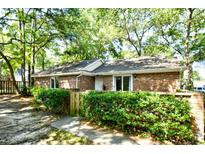 Charming brick home featuring mature landscaping and a well-maintained front yard at 816 Kittiwake Ln., Murrells Inlet, SC 29576