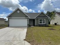 Charming single-story home featuring a two-car garage and manicured front lawn at 934 Padgett Lane, Conway, SC 29526