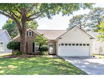 Charming single-story home with brick and siding, lush lawn and mature shade tree at 9569 Indigo Club Dr., Murrells Inlet, SC 29576