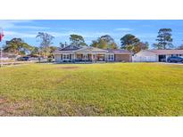 Charming single-story home with a spacious front yard and inviting covered porch at 1014 Thomas Ave., North Myrtle Beach, SC 29582