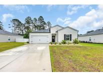 Charming single-story home features a manicured lawn and attached garage at 112 Carolina Lakes Blvd., Myrtle Beach, SC 29588
