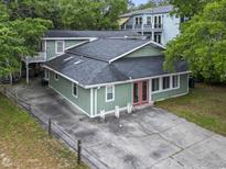Inviting home exterior with a spacious driveway and mature trees in a tranquil neighborhood at 113 Woodland Dr., Murrells Inlet, SC 29576