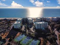 Stunning aerial view of a beachfront condo complex with tennis courts and ocean views at 125 South Dunes Dr., Pawleys Island, SC 29585