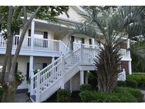 Inviting condo exterior with building number, stairs, and well-maintained landscaping at 1266 River Oaks Dr. # 12-F, Myrtle Beach, SC 29579