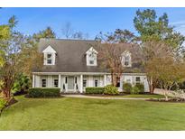 Charming home with a well-manicured lawn, mature landscaping, and a welcoming facade at 2170 Deerfield Ave., Surfside Beach, SC 29575