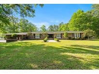 Expansive front yard with classic brick ranch home, mature trees, and manicured landscaping at 3173 Long Avenue Ext., Conway, SC 29526