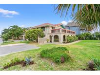 Charming mediterranean-style home featuring lush landscaping and a beautiful brick facade at 807 N Waccamaw Dr., Murrells Inlet, SC 29576