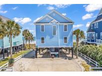 Charming, elevated light blue coastal home with beach views at 969 S Waccamaw Dr., Garden City Beach, SC 29576