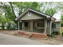 Modest home with olive green siding, a small front porch, and a brick stairway at 1744 John St., Conway, SC 29527
