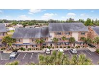 Beautiful condo complex with palm trees and ample parking spaces for residents and visitors at 207 Double Eagle Dr. # F-3, Myrtle Beach, SC 29575