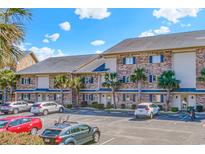 Charming brick condos featuring blue shutters and well-maintained landscaping at 207 Double Eagle Dr. # F-3, Myrtle Beach, SC 29575