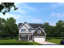Charming two-story home with gray and brown siding, complemented by a well-manicured lawn and a two car garage at 2222 Hazel Way, Longs, SC 29568