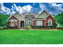 Charming brick home with a manicured lawn, lush landscaping, and great curb appeal at 4260 Long Avenue Ext., Conway, SC 29526