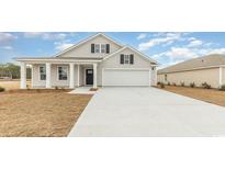 Charming one-story home with a well-manicured lawn and a spacious two-car garage, creating a welcoming curb appeal at 4458 East Coast Ln., Shallotte, NC 28470