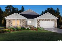 Charming two-story home with stone accents, manicured lawn, and inviting curb appeal at 4857 Hopespring St., Myrtle Beach, SC 29579