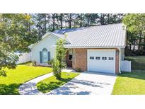 Charming one-story home featuring a metal roof, brick accents, and an attached one-car garage at 9664 Middleton Ct., Murrells Inlet, SC 29576