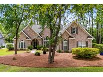 Charming brick home featuring mature trees, manicured landscaping, and an inviting front entrance at 1315 Cherry Dr., Surfside Beach, SC 29575