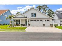 Charming white home with a three-car garage and inviting front porch, set in a well-maintained community at 1340 Jolly Roger Dr., North Myrtle Beach, SC 29582