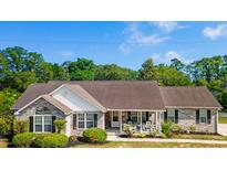 Charming single-story home with well-maintained landscaping and a welcoming front porch at 1566 Bessent Ave., Little River, SC 29566