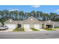 Charming townhomes featuring attached garages and meticulously landscaped front yards at 2016 Willow Run Dr. # B, Little River, SC 29566