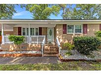 Charming brick home entrance with a cozy front porch and well-maintained landscaping at 2519 Reta St., Conway, SC 29526