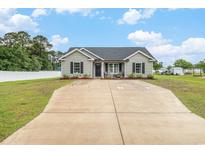 Charming single-story home featuring a well-manicured lawn, long driveway, and inviting front porch at 2521 Wise Rd., Conway, SC 29526