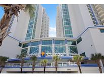 Beautiful Avista Resort entrance view with palm trees and bright blue sky in North Myrtle Beach at 304 North Ocean Blvd. # 506, North Myrtle Beach, SC 29582