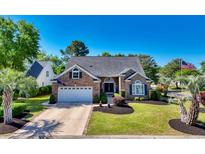 Charming single-story brick home with an attached garage, manicured lawn, and mature landscaping at 4 Stillwater Ct., Murrells Inlet, SC 29576