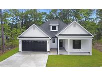 Charming home featuring white siding, a black garage door, and a cozy covered front porch at 4120 Whatuthink Rd., Myrtle Beach, SC 29588