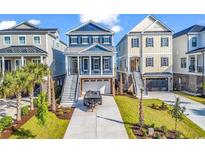 Charming coastal-style home with a two-story design, a covered porch, and a well-manicured front yard at 437 Saint Julian Ln., Myrtle Beach, SC 29579