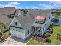 Charming two-story home with a two-car garage, a red-roofed dormer and well-manicured lawn at 5032 Middleton View Dr., Myrtle Beach, SC 29579