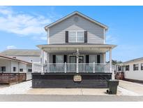 Charming two-story home featuring a cozy front porch and a beautifully maintained exterior at 6001 S Kings Hwy., Myrtle Beach, SC 29575