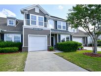 Charming two-story home features a one-car garage, balcony and well-maintained landscaping and a manicured lawn at 6172 Catalina Dr. # 515, North Myrtle Beach, SC 29582