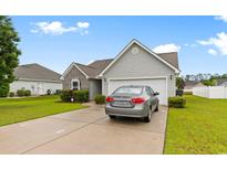 Charming single-Gathering home with a two-car garage, landscaped yard, and a private driveway at 696 Rambler Ct., Myrtle Beach, SC 29588