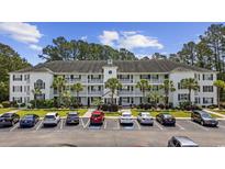 Spacious three-story condominium with palm trees and well-maintained landscaping with ample parking for residents and guests at 760 Charter Dr. # D-4, Longs, SC 29568