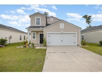 Charming two-story home with a well-maintained lawn and a two-car garage in a suburban neighborhood at 787 Dusty Pine Way, Myrtle Beach, SC 29588