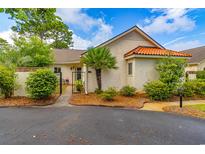 Charming home featuring a Mediterranean style roof, brick wall, and inviting gated entrance at 8 Martinique Dr., Myrtle Beach, SC 29572