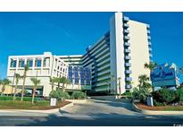 A beachfront resort featuring multiple floors, a beautiful entrance, and lush tropical landscaping at 1105 S Ocean Blvd. # 814, Myrtle Beach, SC 29577