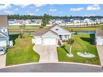 Charming single-story home with a well-manicured lawn, three-car garage, and inviting curb appeal at 1124 Valetto Loop, Myrtle Beach, SC 29579