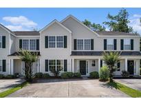 Charming townhome with well-maintained landscaping and neutral siding under a bright blue sky at 1196 Harvester Circle # 1196, Myrtle Beach, SC 29579