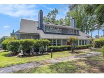 Charming two-story home with mature landscaping, gray siding, and a well-maintained front yard at 1206 Erin Way # A, Myrtle Beach, SC 29577
