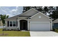 Charming single-story home with a two-car garage and well-manicured lawn, showcasing curb appeal at 157 Stride Ct., Myrtle Beach, SC 29588