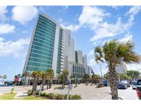 Grand high-rise building with modern architecture, palm trees, and ample parking in an idyllic location at 201 S Ocean Blvd. # 1112, Myrtle Beach, SC 29577