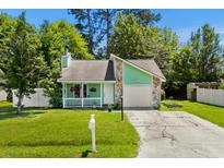 Charming home with a stone accent wall, a cozy front porch, and well-maintained landscaping at 202 Millstone Dr., Myrtle Beach, SC 29588