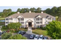 Attractive multi-Gathering home boasts well-maintained landscaping, private balconies, and convenient parking at 260 Woodlands Way # 2, Calabash, NC 28467