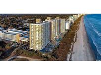 An aerial view of a beachfront resort with pools, parking garage, and multiple high-rise buildings along a sandy coastline at 2701 S Ocean Blvd. # 902, North Myrtle Beach, SC 29582