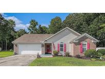 Charming single-story home featuring a brick facade, well-maintained lawn, and an attached two-car garage at 271 Sienna Dr., Little River, SC 29566