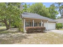 Charming single-story home with tan siding, front porch, and mature landscaping at 2712 Austin Ave., Conway, SC 29527