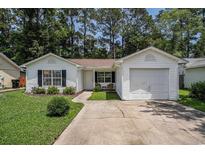 Charming single story home with white siding, manicured lawn, and attached garage at 2768 Temperance Dr., Myrtle Beach, SC 29577